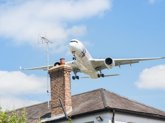 view of airplane and a house